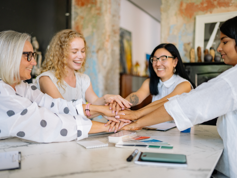 women entrepreneurs collaborating because of financial therapy