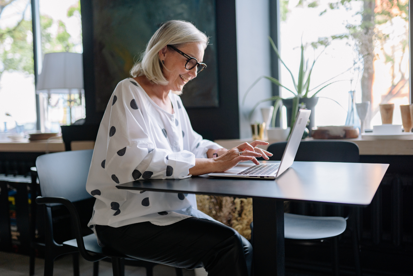 Happy middle aged woman on financial therapy call session computer