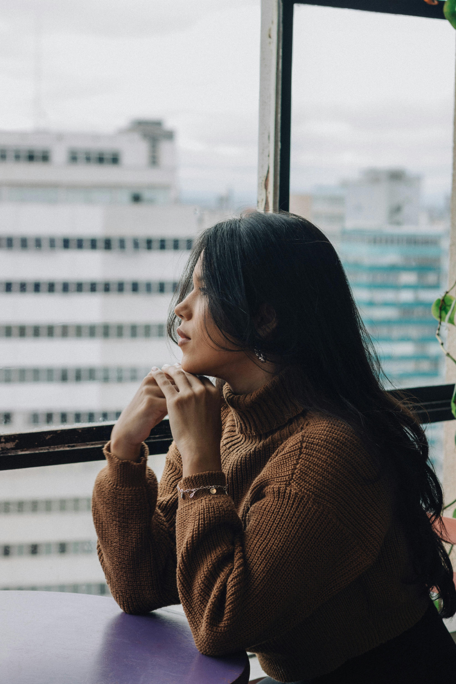 woman deep in thought looking out a window