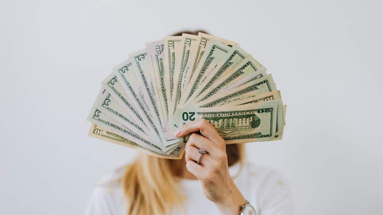 woman holding cash money heal your relationship with money