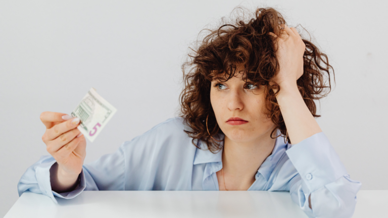 Woman looking at a 5 dollar bill