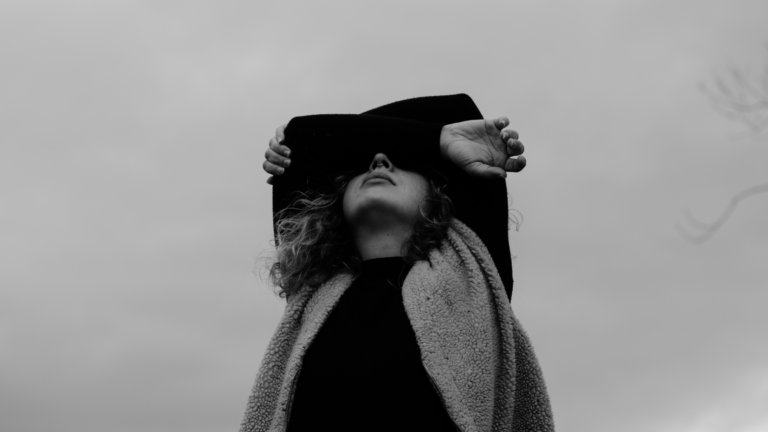 woman covering her face bad with money